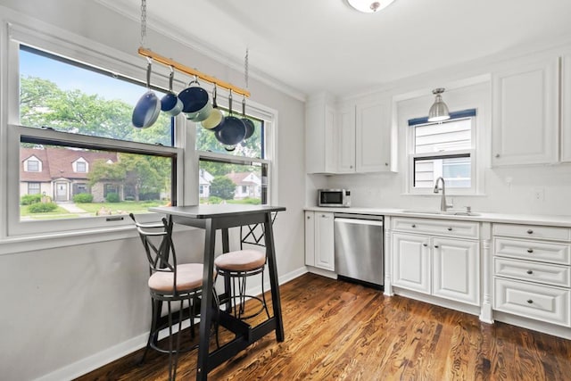 5629 35th Ave S, Minneapolis, MN 55417 - kitchen featuring stainless steel appliances, a sink, white cabinetry, healthy amount of natural light, and crown molding