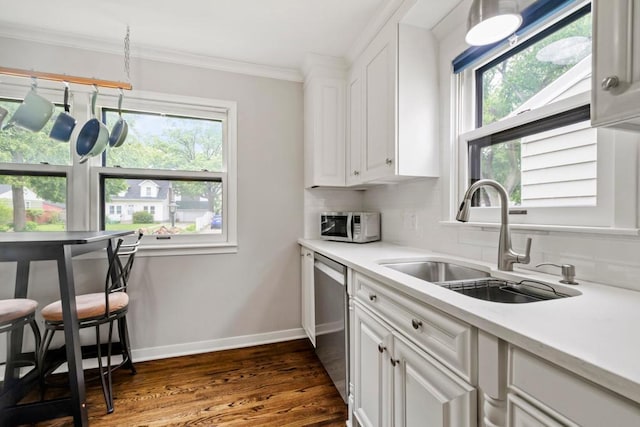 5629 35th Ave S, Minneapolis, MN 55417 - kitchen featuring a sink, appliances with stainless steel finishes, dark wood-style flooring, ornamental molding, and white cabinetry