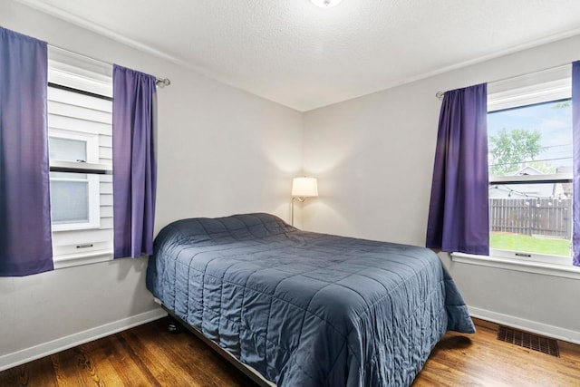 5629 35th Ave S, Minneapolis, MN 55417 - bedroom with wood finished floors, baseboards, and a textured ceiling