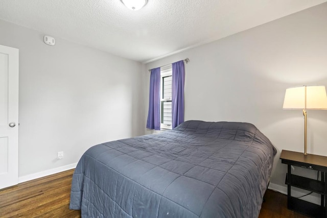 5629 35th Ave S, Minneapolis, MN 55417 - bedroom featuring baseboards, wood finished floors, and a textured ceiling