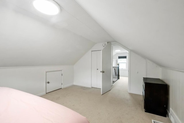 5629 35th Ave S, Minneapolis, MN 55417 - unfurnished bedroom featuring light carpet, vaulted ceiling, and baseboards