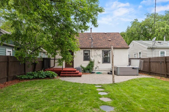 5629 35th Ave S, Minneapolis, MN 55417 - rear view of house featuring a hot tub, roof with shingles, a patio area, stucco siding, and a deck