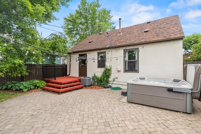 5629 35th Ave S, Minneapolis, MN 55417 - view of patio / terrace with a deck, a hot tub, and central AC unit