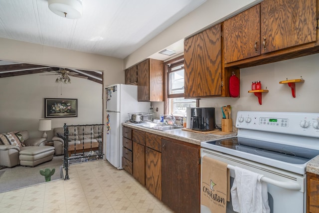 412 Hill Ave, Crookston, MN 56716 - kitchen featuring white appliances, a sink, light flooring, open floor plan, and ceiling fan