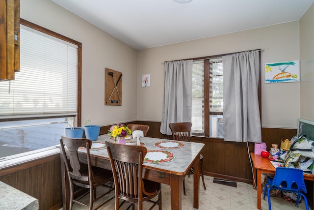 412 Hill Ave, Crookston, MN 56716 - dining area featuring wainscoting, light flooring, and wooden walls
