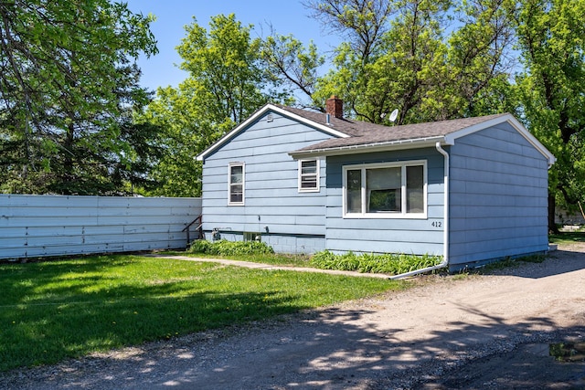 412 Hill Ave, Crookston, MN 56716 - view of side of property with a chimney and roof with shingles