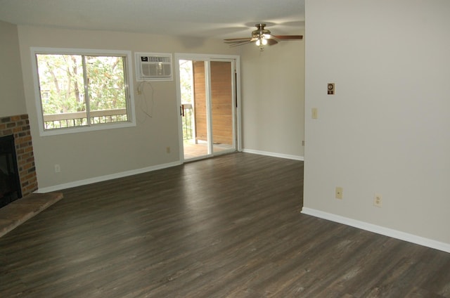7600 157th St W Unit 307, Apple Valley, MN 55124 - unfurnished living room featuring a wall mounted air conditioner, a brick fireplace, baseboards, a ceiling fan, and dark wood finished floors