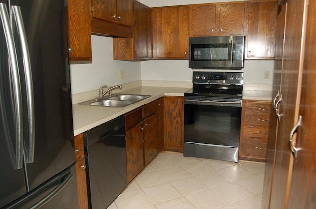 7600 157th St W Unit 307, Apple Valley, MN 55124 - kitchen with black appliances, a sink, light countertops, and brown cabinetry