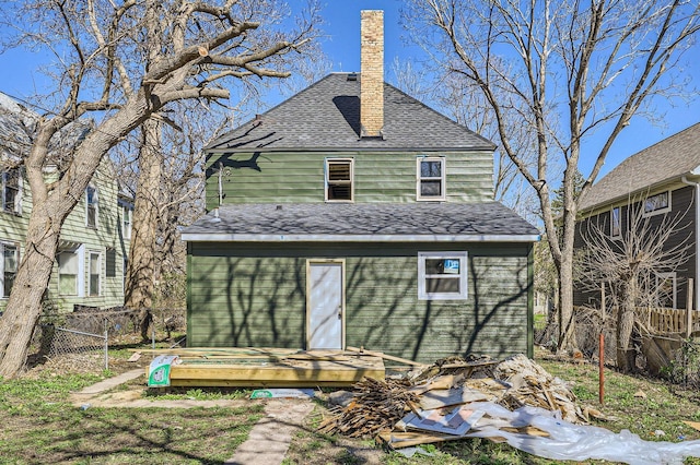 2217 Fremont Ave N, Minneapolis, MN 55411 - back of house with a shingled roof, fence, a chimney, and an outdoor structure