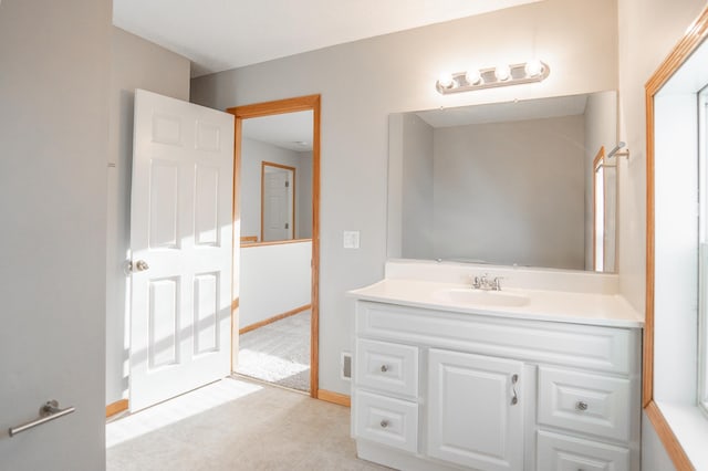 bathroom with vanity and baseboards