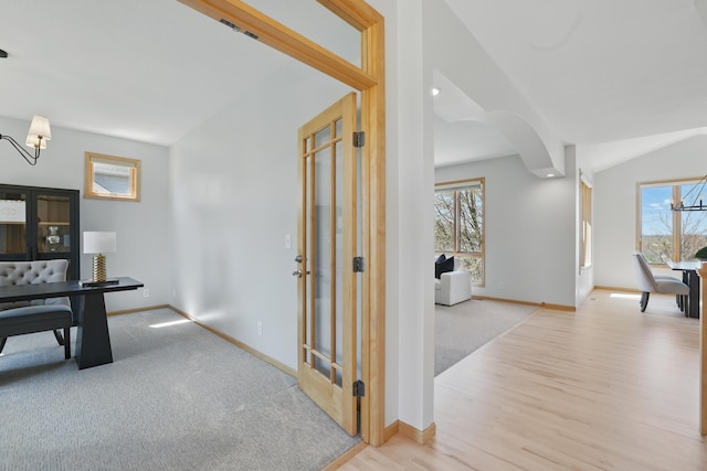 2464 Cottage Grove Dr, Woodbury, MN 55129 - hallway featuring a chandelier, plenty of natural light, and baseboards
