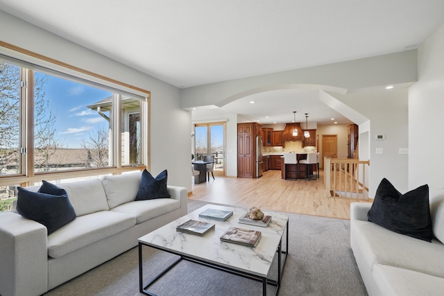 2464 Cottage Grove Dr, Woodbury, MN 55129 - living room featuring arched walkways, healthy amount of natural light, recessed lighting, and light wood-style floors
