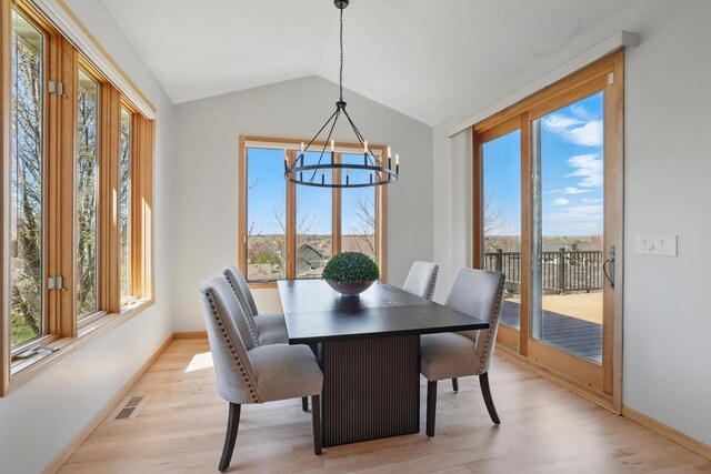 2464 Cottage Grove Dr, Woodbury, MN 55129 - dining room with light wood-style flooring, a chandelier, healthy amount of natural light, and vaulted ceiling