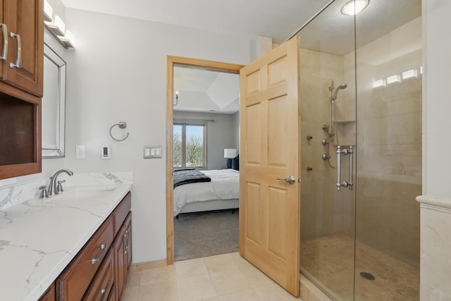 2464 Cottage Grove Dr, Woodbury, MN 55129 - ensuite bathroom with a tile shower, vanity, tile patterned floors, and baseboards