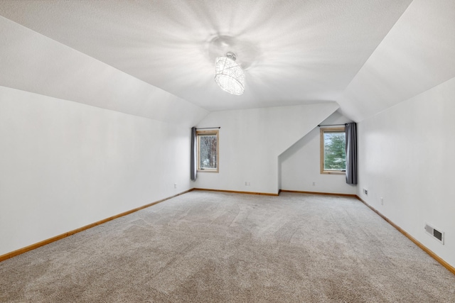 2464 Cottage Grove Dr, Woodbury, MN 55129 - bonus room with carpet floors, lofted ceiling, and baseboards