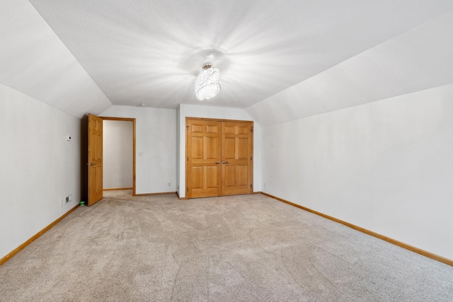 2464 Cottage Grove Dr, Woodbury, MN 55129 - additional living space featuring lofted ceiling, light carpet, and baseboards
