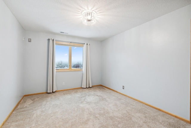 2464 Cottage Grove Dr, Woodbury, MN 55129 - carpeted spare room with baseboards and a textured ceiling
