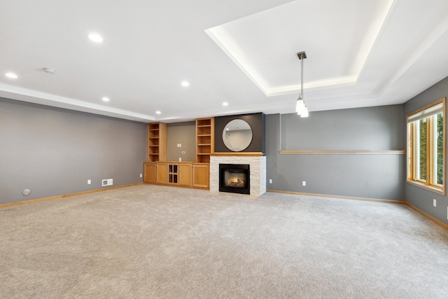 2464 Cottage Grove Dr, Woodbury, MN 55129 - unfurnished living room featuring a tray ceiling, baseboards, light carpet, recessed lighting, and a stone fireplace