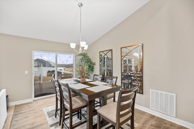 12262 71st St NE, Otsego, MN 55330 - dining space with a chandelier, light wood-type flooring, baseboards, and high vaulted ceiling