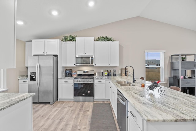 12262 71st St NE, Otsego, MN 55330 - kitchen featuring appliances with stainless steel finishes, a sink, lofted ceiling, a peninsula, and white cabinetry