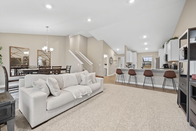 12262 71st St NE, Otsego, MN 55330 - living area with lofted ceiling, recessed lighting, a chandelier, baseboards, and light wood-style flooring