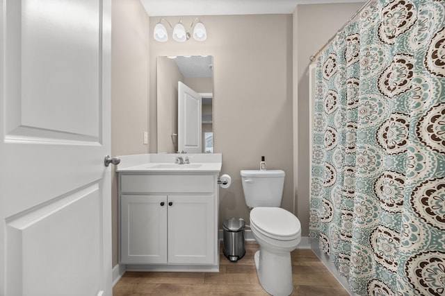 12262 71st St NE, Otsego, MN 55330 - bathroom featuring toilet, vanity, wood finished floors, and baseboards