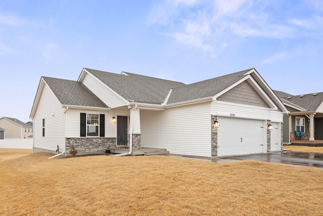 12262 71st St NE, Otsego, MN 55330 - craftsman-style home with stone siding, a front lawn, a shingled roof, and an attached garage
