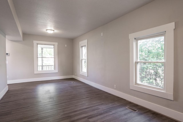1602 Johnson St NE, Minneapolis, MN 55413 - empty room with baseboards, dark wood-type flooring, and a textured ceiling