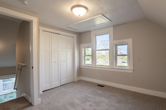 1602 Johnson St NE, Minneapolis, MN 55413 - unfurnished bedroom with attic access, carpet, a closet, a textured ceiling, and baseboards