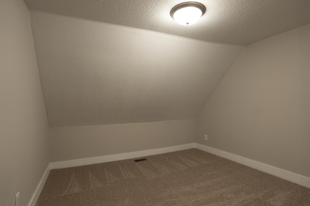 1602 Johnson St NE, Minneapolis, MN 55413 - bonus room with carpet, lofted ceiling, a textured ceiling, and baseboards