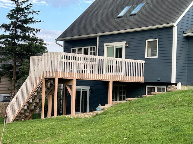 1905 11th St SW, Rochester, MN 55902 - back of house with a yard, a wooden deck, central AC, stairs, and a shingled roof