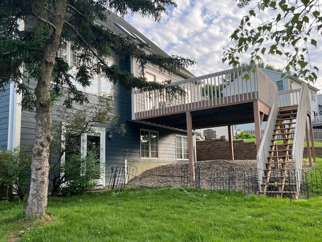 1905 11th St SW, Rochester, MN 55902 - rear view of property featuring a deck, a lawn, and stairs