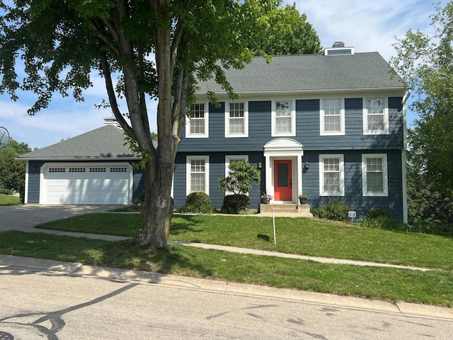 1905 11th St SW, Rochester, MN 55902 - colonial inspired home featuring a front lawn, driveway, and a chimney