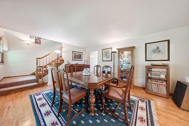 6420 Rolling Hills Rd, Corcoran, MN 55340 - dining space with light wood-style flooring and stairs