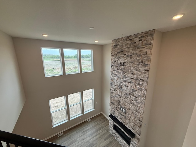 unfurnished living room featuring wood finished floors, recessed lighting, and baseboards