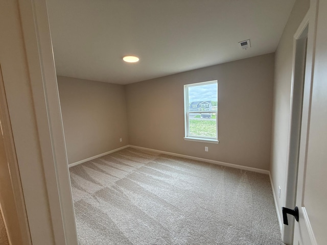 carpeted empty room with baseboards and recessed lighting