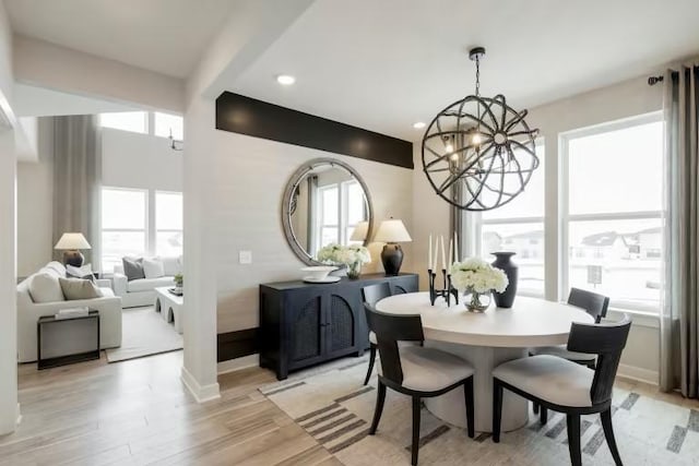 dining space featuring a chandelier, light wood-type flooring, recessed lighting, and baseboards