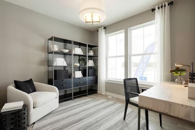 office space with wood finished floors and baseboards