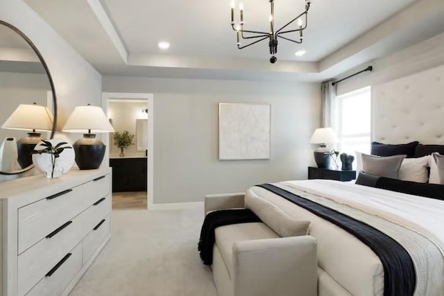 bedroom with a raised ceiling, a chandelier, light colored carpet, connected bathroom, and recessed lighting