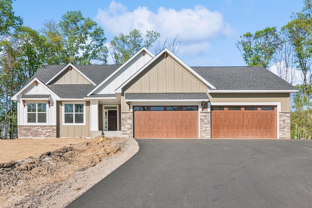 14633 Packard St NE, Ham Lake, MN 55304 - craftsman inspired home with stone siding, board and batten siding, a garage, asphalt driveway, and roof with shingles