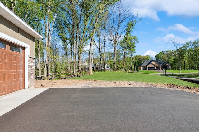 14633 Packard St NE, Ham Lake, MN 55304 - view of green lawn with a garage and driveway