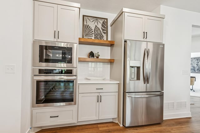 14633 Packard St NE, Ham Lake, MN 55304 - kitchen with appliances with stainless steel finishes, wood finished floors, open shelves, and light countertops