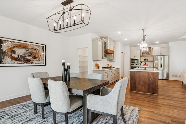 14633 Packard St NE, Ham Lake, MN 55304 - dining area with a chandelier, wood finished floors, and recessed lighting
