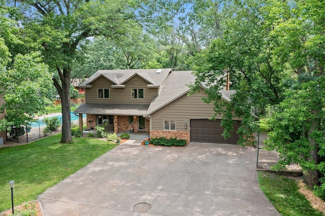 9755 Egret Blvd NW, Coon Rapids, MN 55433 - view of front of property with covered porch, driveway, a shingled roof, a garage, and brick siding