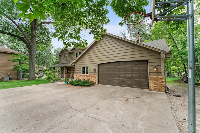 9755 Egret Blvd NW, Coon Rapids, MN 55433 - view of front of house with brick siding, concrete driveway, and an attached garage