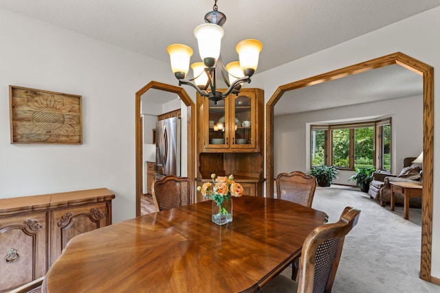 9755 Egret Blvd NW, Coon Rapids, MN 55433 - dining space featuring a chandelier, light colored carpet, and arched walkways