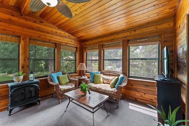 9755 Egret Blvd NW, Coon Rapids, MN 55433 - carpeted living area with lofted ceiling, a wood stove, healthy amount of natural light, wooden walls, and ceiling fan