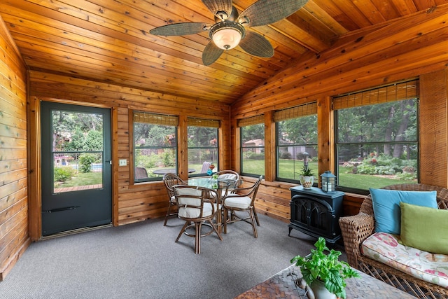 9755 Egret Blvd NW, Coon Rapids, MN 55433 - sunroom featuring a wood stove, wooden walls, carpet, and wood ceiling