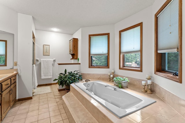 9755 Egret Blvd NW, Coon Rapids, MN 55433 - full bathroom featuring vanity, a bath, a textured ceiling, and tile patterned flooring