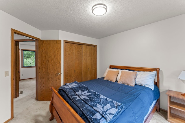 9755 Egret Blvd NW, Coon Rapids, MN 55433 - bedroom with light carpet, a closet, and a textured ceiling